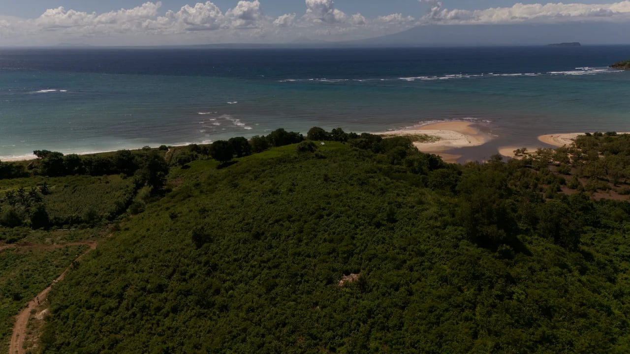 View from the summit of the hill looking south over the bay, beach and open Indian Ocean